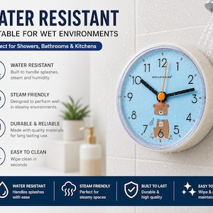 May include: A round, water-resistant wall clock with a light blue face featuring a bear illustration and the text HELLOBEAR. The clock has black hour and minute hands, an orange second hand, and is mounted on a white tiled wall near a shower head.