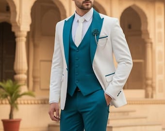 May include: A three-piece suit with a white jacket, teal vest, and teal pants. The jacket has teal lapels and pocket trim. A white tie and a floral lapel pin complete the look. The suit is paired with brown leather dress shoes.