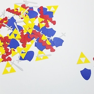 May include: A pile of colorful paper cutouts in the shapes of hearts, triangles, swords, and shields. The shapes are in red, yellow, blue, and white.