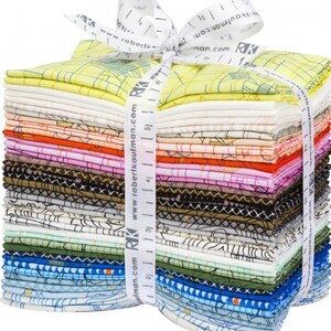 May include: A stack of colorful fabric squares, tied with a white ribbon printed with "www.robertkaufman.com". The fabric features various patterns and colors, including yellow, pink, blue, and black. The ribbon is marked with measurements.