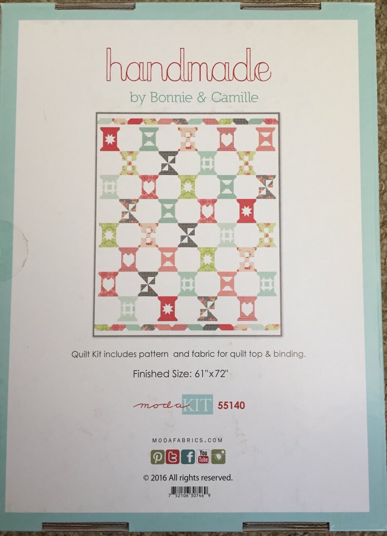 May include: A quilt kit by Bonnie & Camille with a finished size of 155cm x 183cm. The kit includes fabric and pattern for the quilt top and binding. The quilt design features a repeating pattern of spools in red, green, black, and blue.