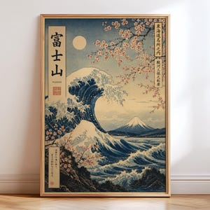 May include: Framed print of a classic Japanese woodblock print depicting a large ocean wave with Mount Fuji in the background. The artwork features shades of blue, white, and beige, with cherry blossoms and Japanese text.