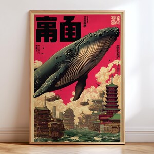 以下が含まれることがあります： 日本の都市の上を飛ぶクジラを描いた額入りのアートプリント。アートワークは赤い背景で、上部に日本語のテキストがあります。クジラは濃い灰色で、建物は緑と茶色のトーンで詳細に描かれています。