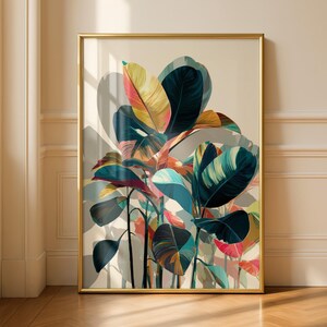 May include: A framed art print featuring a vibrant botanical illustration. The artwork showcases large, colorful leaves in shades of teal, yellow, pink, and orange against a neutral background. The gold frame adds a touch of elegance to the piece.