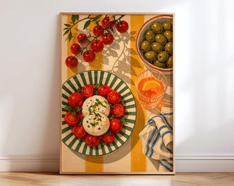 May include: A framed art print featuring a top-down view of a table setting with a plate of burrata cheese and sliced tomatoes, a bowl of green olives, a glass of orange liquid with a citrus slice, and a blue and white striped napkin.