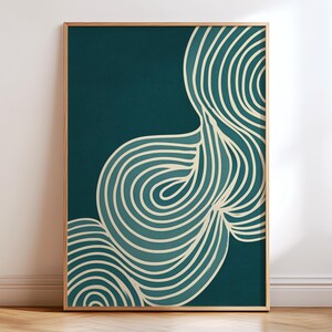 May include: Abstract art print featuring a teal background with cream-colored, swirling, wave-like lines. The artwork is framed in a natural wood tone, creating a modern and minimalist aesthetic. The print is displayed on a wooden floor.