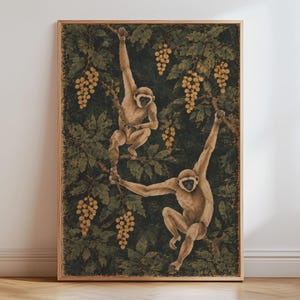 May include: A framed vertical wall art print featuring two light brown gibbons climbing through a dense forest of dark green leaves and clusters of golden yellow grapes. The monkeys are depicted in motion, reaching for branches within the foliage.