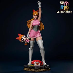 May include: A detailed figurine of Blossom from The Powerpuff Girls. She is wearing a pink dress, white gloves, and boots, with a red bow in her hair. She holds a doll of herself and stands on a base with a red telephone.