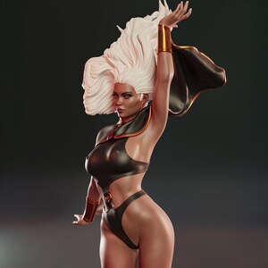 May include: A detailed statue of Storm from the X-Men, featuring a black and gold costume with a flowing cape. The figure has white hair and is posed with one arm raised. The statue is a collectible item.