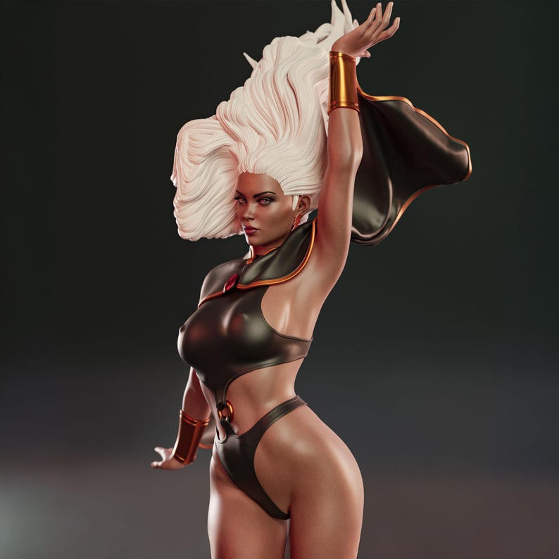 May include: A detailed statue of Storm from the X-Men, featuring a black and gold costume with a flowing cape. The figure has white hair and is posed with one arm raised. The statue is a collectible item.