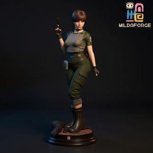 May include: A detailed figurine of a woman in a military-style outfit, holding a handgun. She wears a gray top, green pants, and black boots. The figurine stands on a circular base with a logo. The background is dark, and the figurine is well-lit.