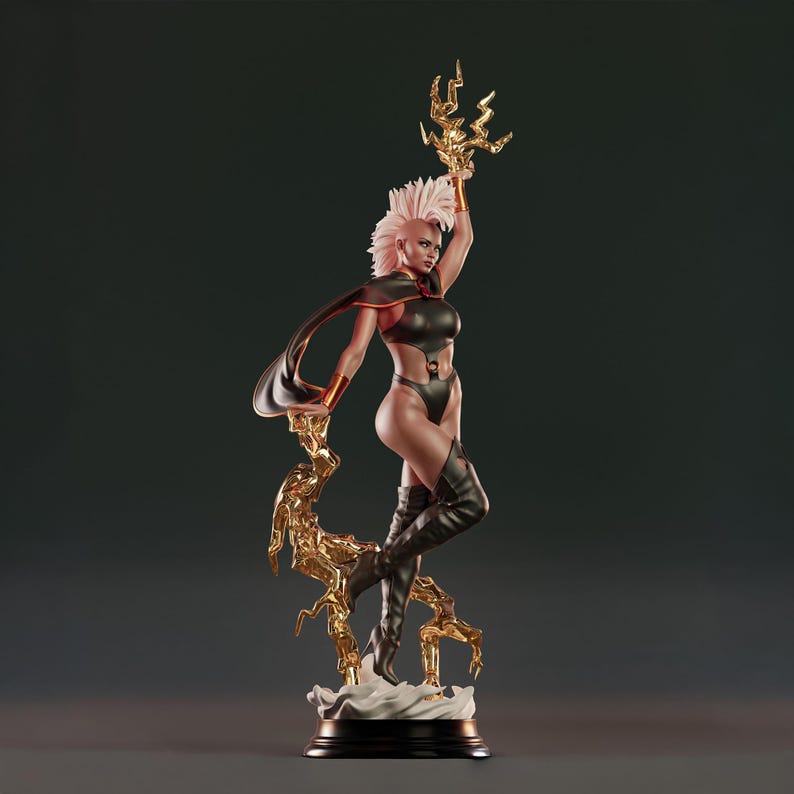 May include: A detailed statue of a superheroine in a dynamic pose, holding a golden lightning bolt. She wears a black bodysuit, boots, and a flowing cape. Her hair is white, and the statue is set on a black base.