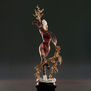 May include: A detailed statue of a female figure with white hair, wearing a black outfit and boots, and a flowing cape. The figure is holding a golden lightning bolt design. The statue is on a black base.