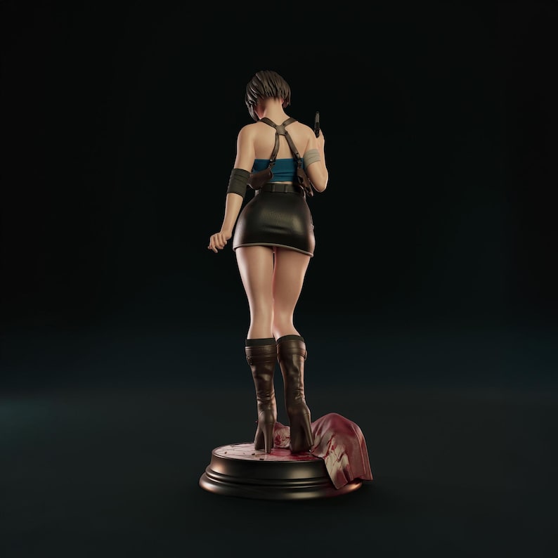 May include: A figurine of a video game character, seen from behind. The figure is dressed in a blue top, black skirt, and brown boots. A small black bag is on the figure's back. The figure stands on a round base with a red cloth.