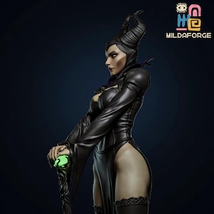 May include: A detailed figurine of a character in a black dress with long sleeves, high slits, and a horned headdress. The figure holds a staff with a glowing green orb. The image has the text "MILDAFORGE" in the upper right corner.