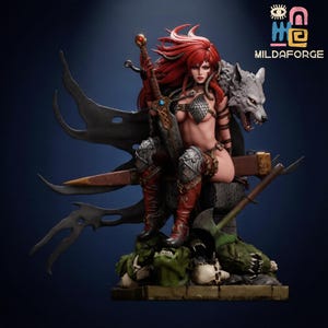 May include: A detailed figurine of a warrior woman with red hair, clad in armor, holding a sword. A wolf statue is behind her. The figure is set on a base with skulls and a green monster. The logo "MILDAFORGE" is visible.