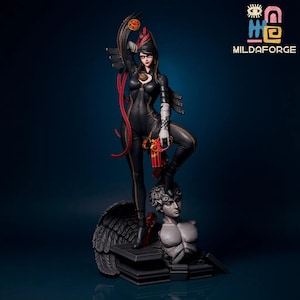 May include: A detailed statue of a woman in a black bodysuit, holding a red and gold gun. The statue is standing on a bust of a man with angel wings. The statue has gold accents and is set against a dark blue background. The text "MILDAFORGE" is in the upper right corner.