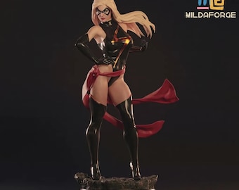 May include: A detailed figurine of a female superhero in a dynamic pose. She wears a black and gold bodysuit, black gloves, and thigh-high boots. A red sash flows from her waist. The figure has blonde hair and a mask. The base is dark with the text "MILDAFORGE".