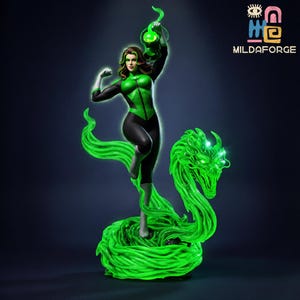 May include: A Green Lantern statue featuring a female figure in a black and green suit, holding a green lantern aloft. The figure stands on a glowing green dragon-like structure. The statue has a dark background and the logo "MILDAFORGE".