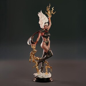 May include: A detailed figurine of Storm, a superheroine, in a dynamic pose. She wears a black bodysuit, boots, and cape, with white hair and a golden lightning bolt. The statue is on a black base with a gold-colored support.