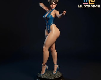 May include: A detailed figurine of a woman in a blue bodysuit, posed in a fighting stance. The figure has dark hair styled in buns and is wearing blue sandals. The base is dark with a textured surface. The logo "MILDAFORGE" is in the upper right corner.