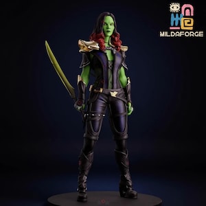 May include: A detailed figurine of a green-skinned character with red hair, holding a yellow sword. The figure wears a black and purple outfit with gold accents. The figure is standing on a black base. The logo "MILDAFORGE" is in the upper right corner.