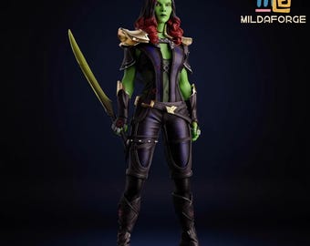 May include: A detailed figurine of a green-skinned character with red hair, holding a yellow sword. The figure wears a black and purple outfit with gold accents. The figure is standing on a black base. The logo "MILDAFORGE" is in the upper right corner.