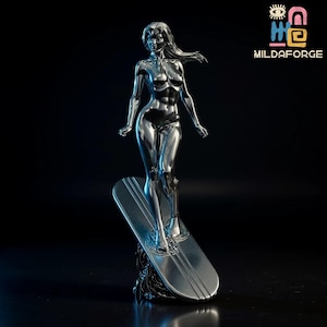 May include: A chrome-finished sculpture of a woman standing on a surfboard. The figure has flowing hair and is posed in a dynamic stance. The surfboard has parallel lines. The sculpture is set against a dark background.