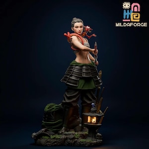 May include: A detailed figurine of a warrior woman in a traditional outfit, holding a sword. A small red dragon rests on her shoulder. The figure is set against a dark background, with a lantern at her feet. The figurine is a collectible item.
