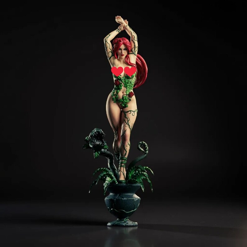 May include: A figurine of a woman with red hair and green vines covering her body, standing on a dark green pot with plants. The figure has her arms raised above her head. The background is black.