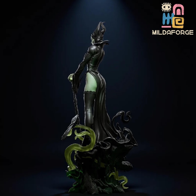 May include: A black figurine of a character with a horned headdress and long, flowing gown. The figure is posed with a staff and stands on a dark base with green accents. The figure is a stylized representation of a fantasy character.