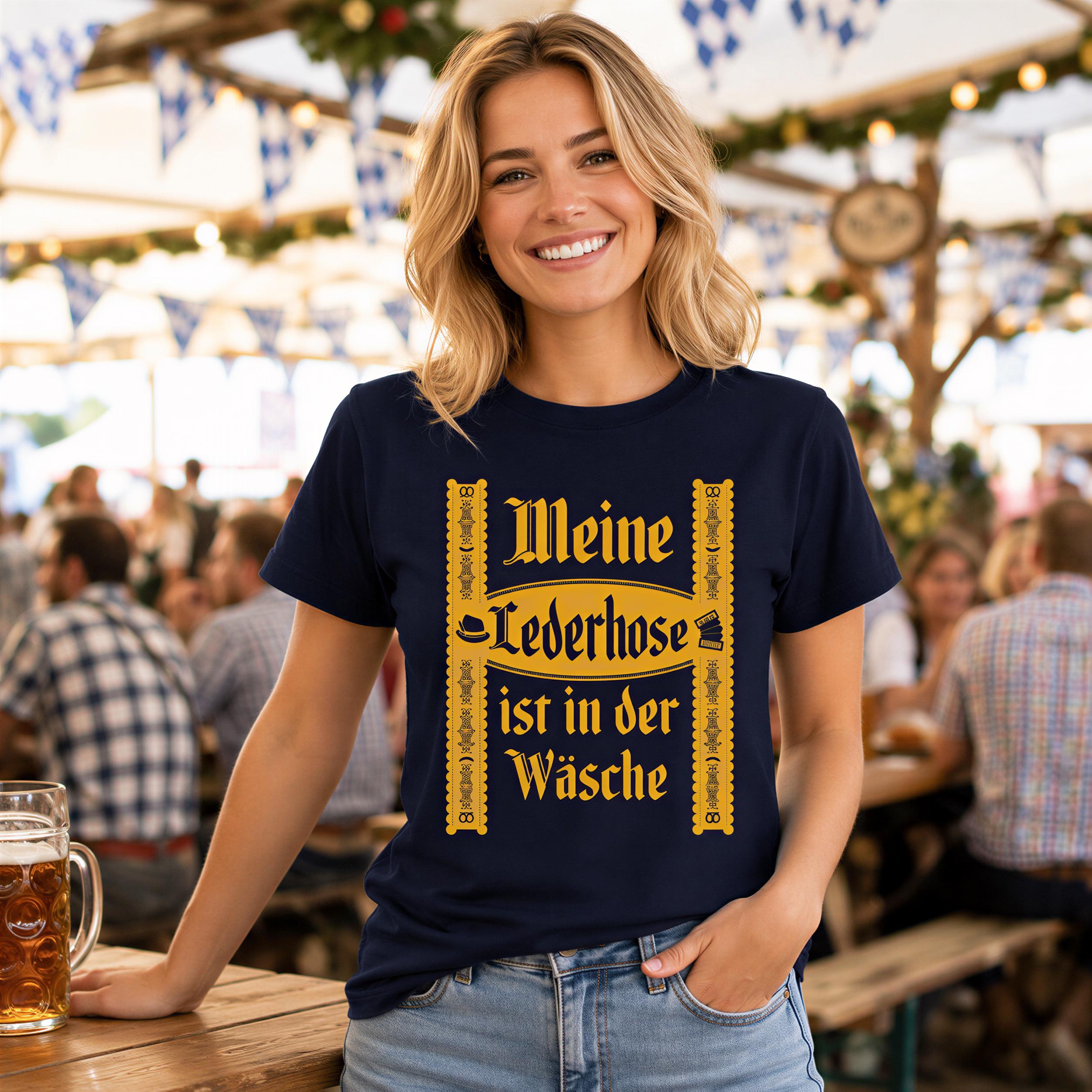 A smiling woman wearing a navy blue t-shirt with a graphic design and text printed on it, standing in a crowded bar or restaurant.