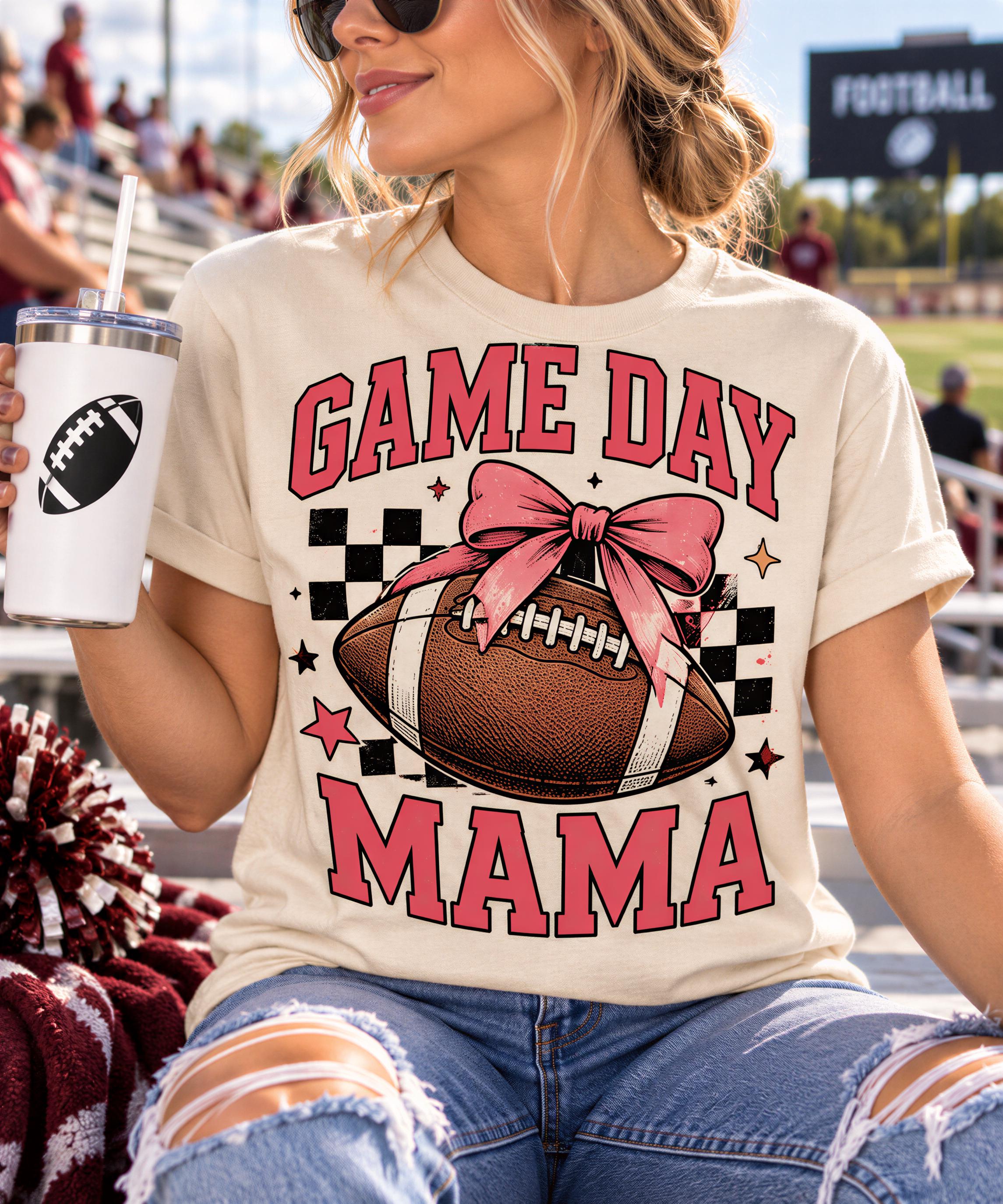 A woman wearing a white t-shirt with a graphic of a football and the text "GAME DAY MAMA" is sitting on a bleachers, holding a drink.