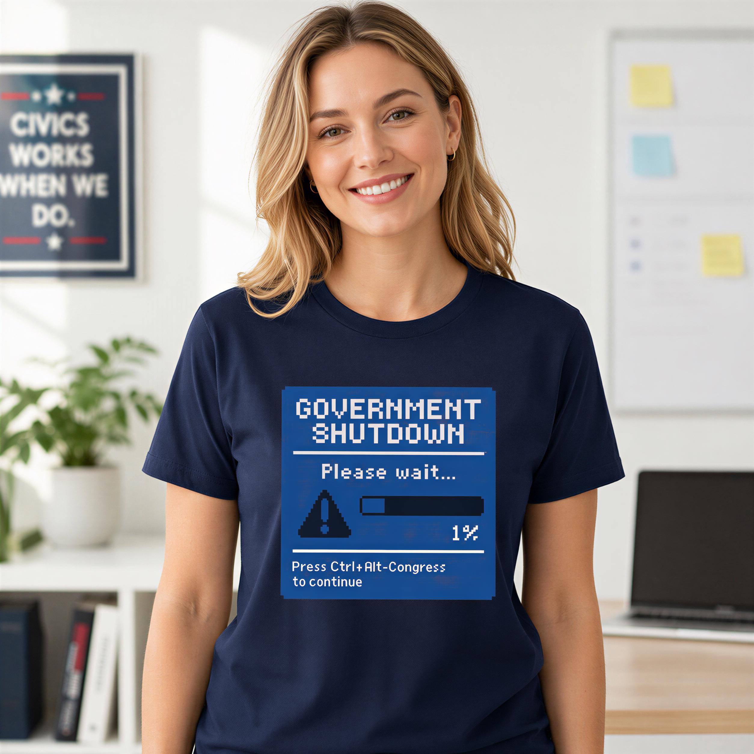 A woman wearing a navy blue t-shirt with a graphic design that says "GOVERNMENT SHUTDOWN Please wait... 1% Press Clr-ht- Congress to continue".