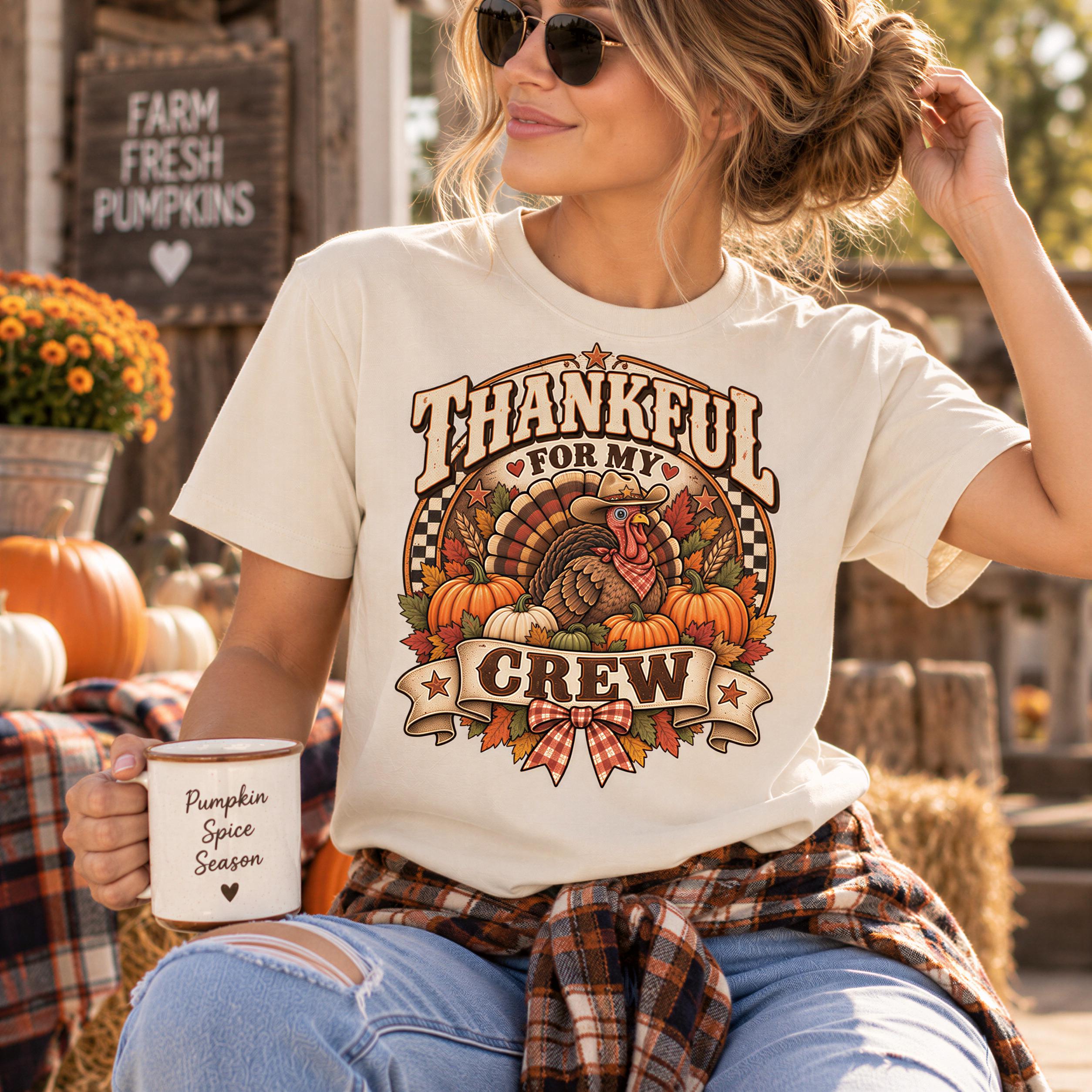 A woman wearing a white t-shirt with a graphic design of a turkey and autumn leaves, holding a pumpkin spice coffee mug and wearing sunglasses.