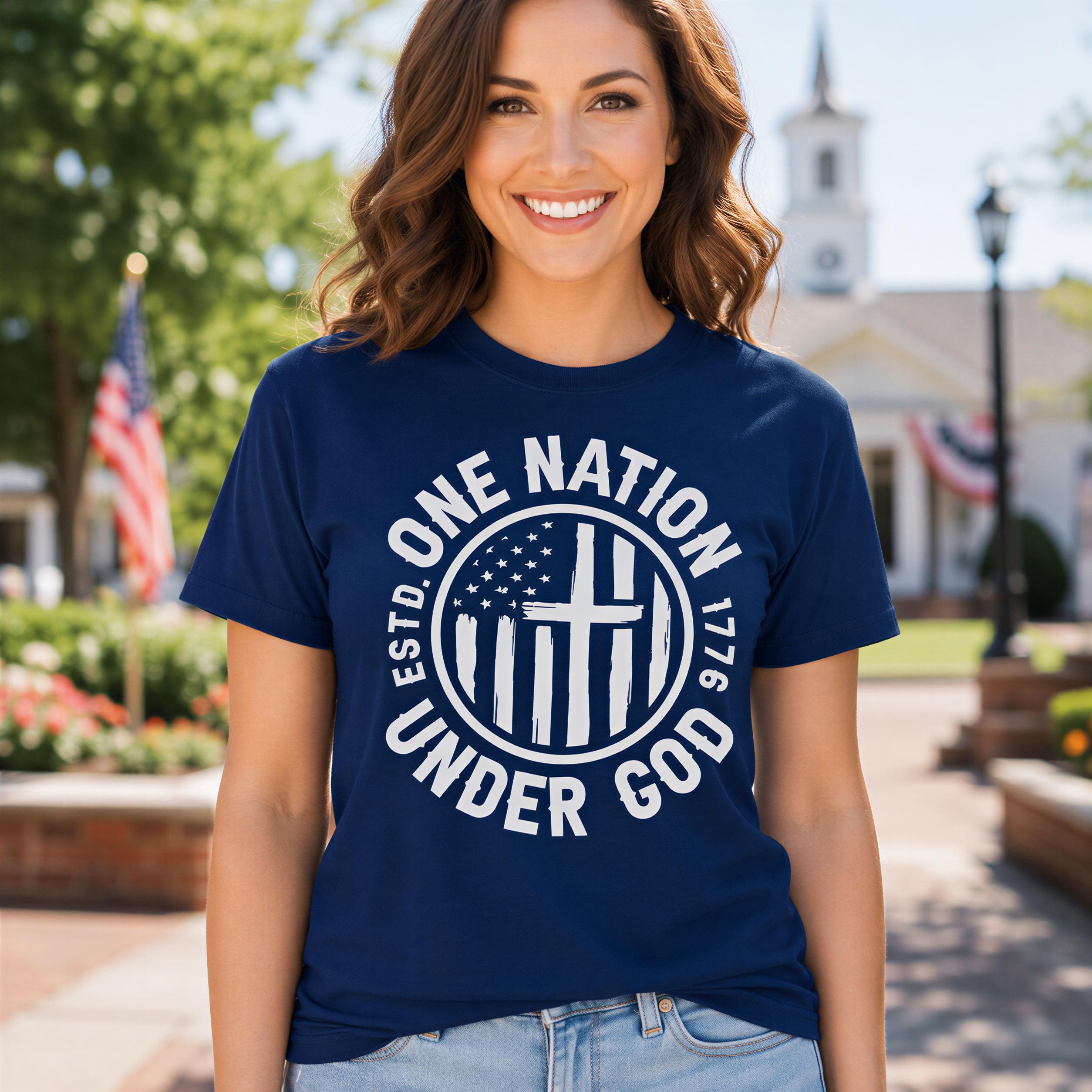A woman wearing a navy blue t-shirt with the text "ONE NATION UNDER GOD" and an American flag in the background.