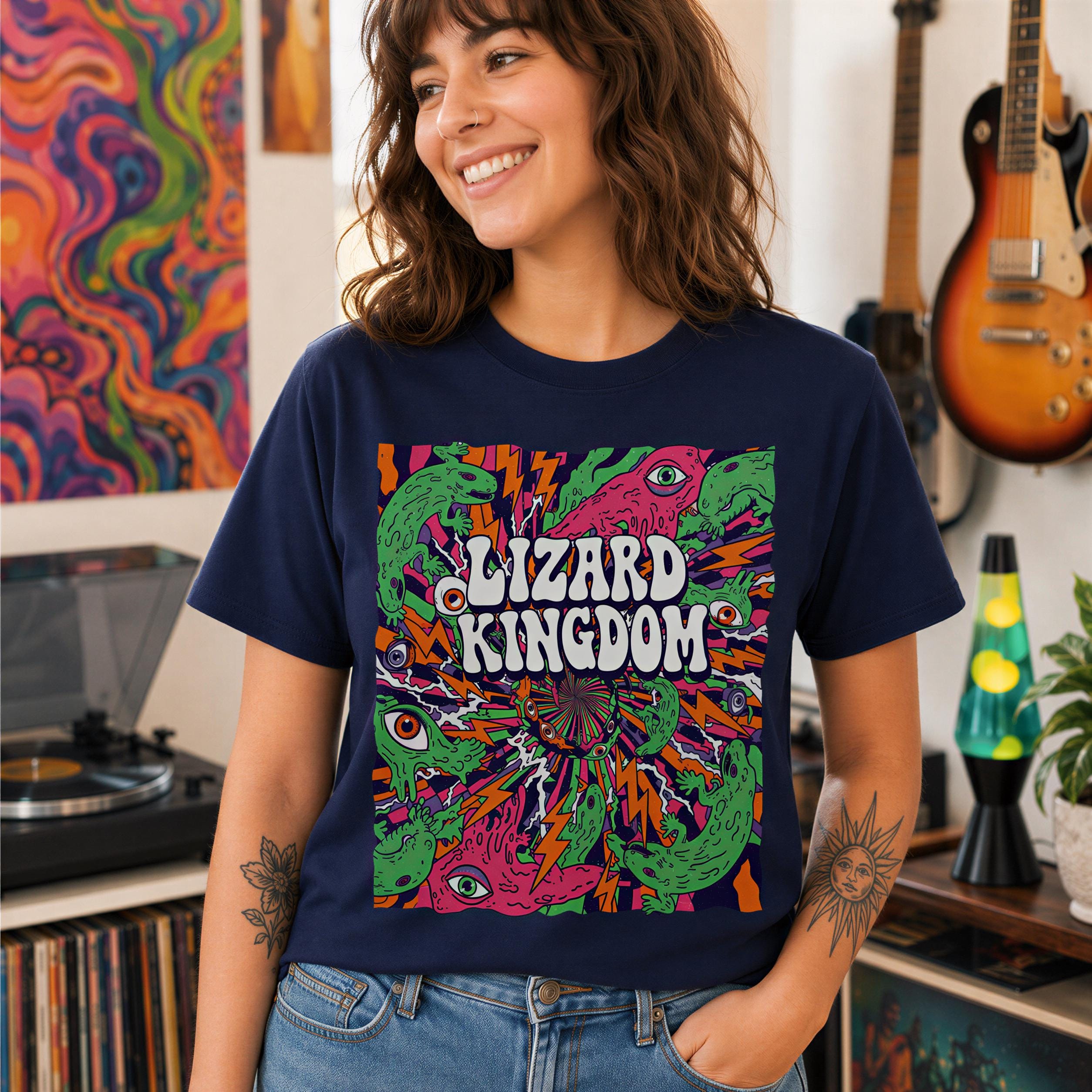 A smiling woman wearing a blue t-shirt with a colorful, psychedelic design featuring a lizard and the text "LIZARD KINGDOM".