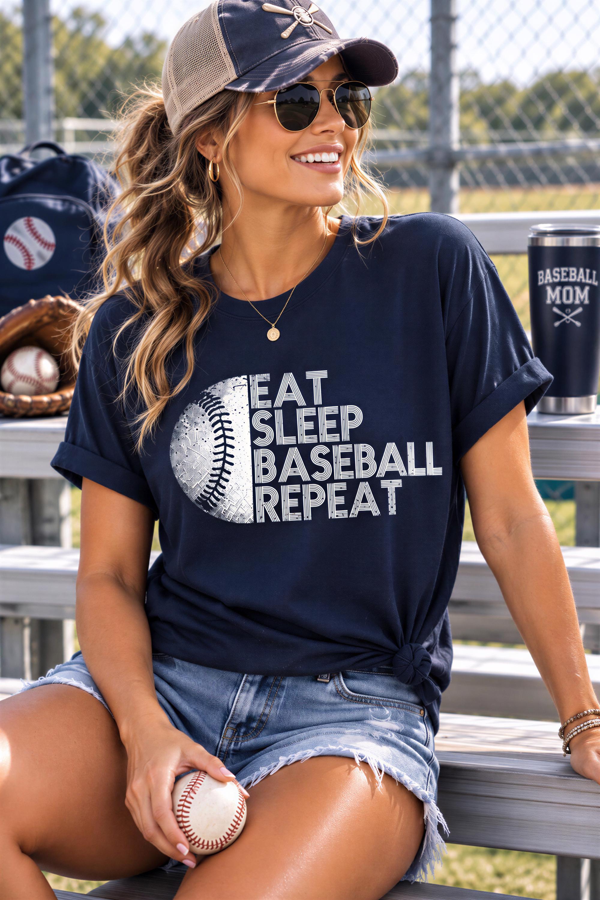 A woman wearing a baseball cap, sunglasses, and a t-shirt with the text "EAT SLEEP BASEBALL REPEAT" is sitting on a bench, holding a baseball.