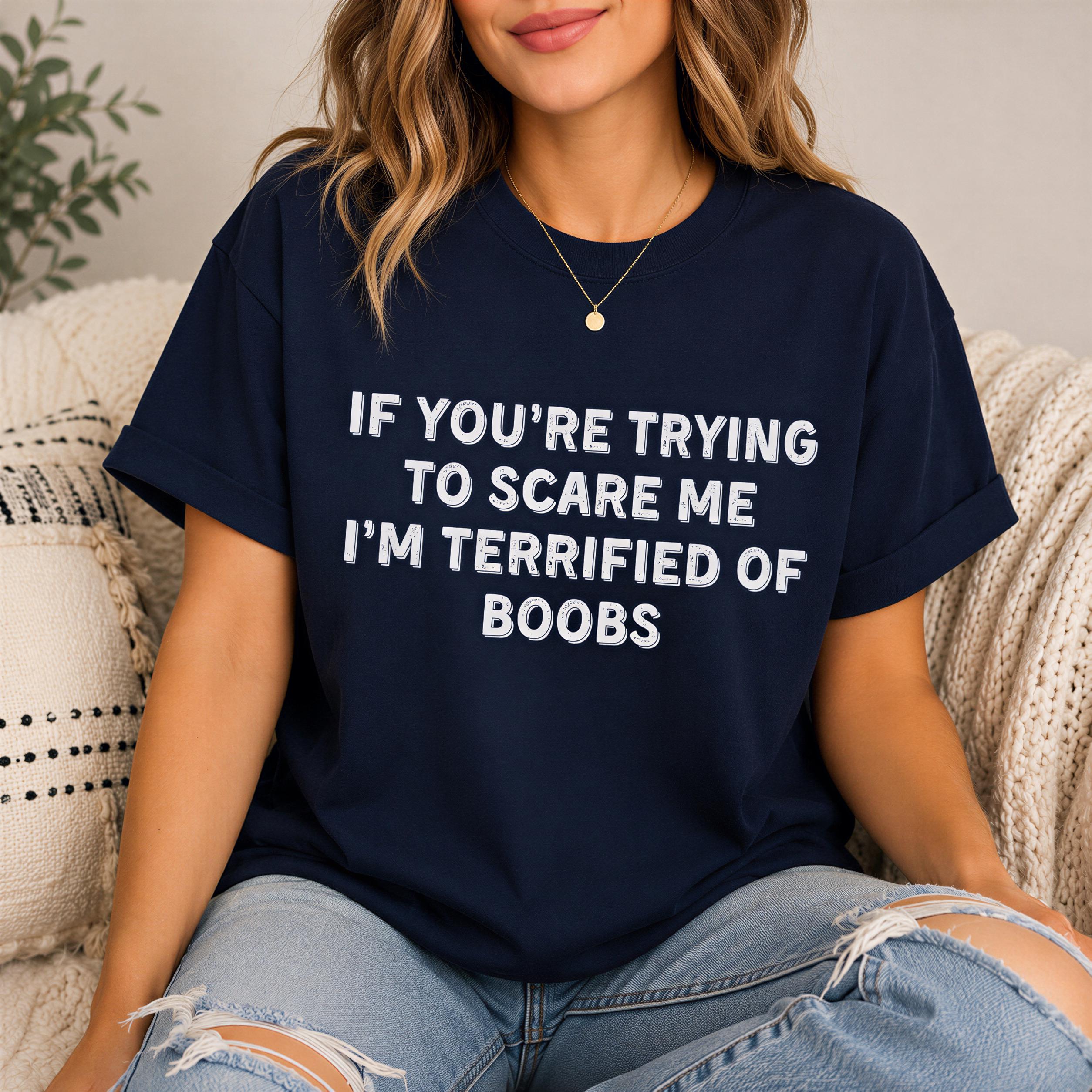 A woman wearing a navy blue t-shirt with the text "IF YOU'RE TRYING TO SCARE ME I'M TERRIFIED OF BOBS" printed on it.