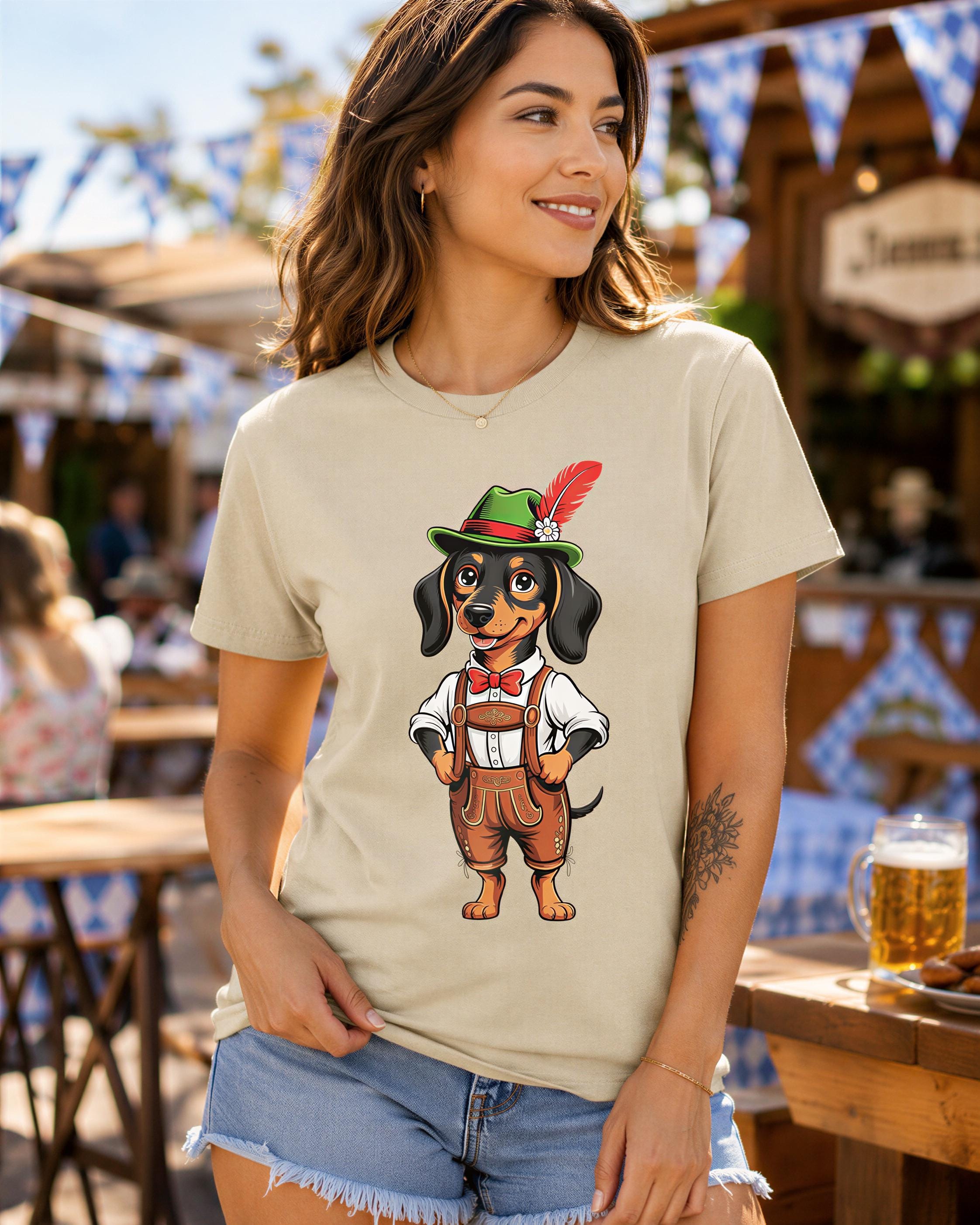 A woman wearing a t-shirt with a cartoon image of a dachshund wearing a hat and overalls, standing in front of a wooden structure with blue flags.