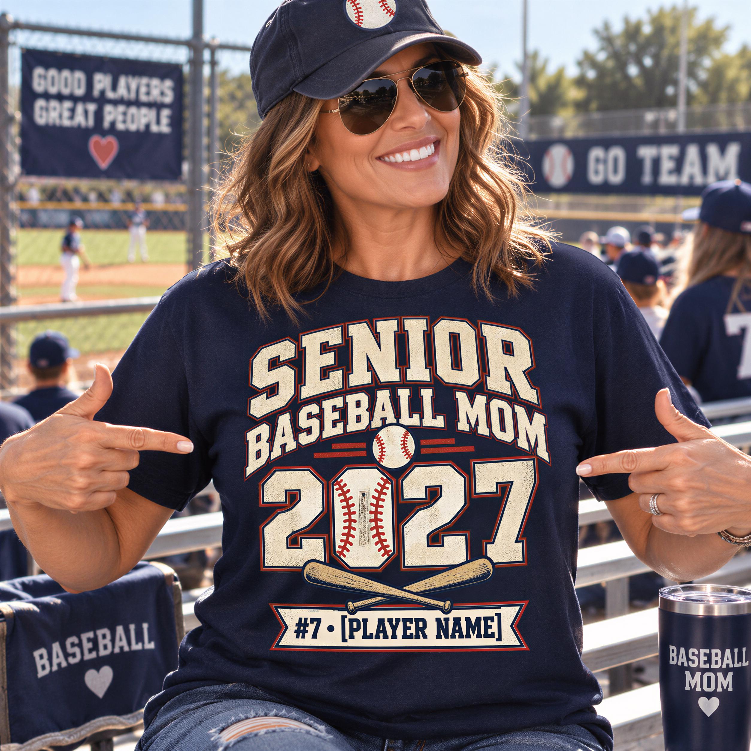 A woman wearing a baseball cap and sunglasses is sitting in a stadium, pointing to her shirt that says "SENIOR BASEBALL MOM 2027" and "#7 (PLAYER NAME)" with a baseball bat graphic.