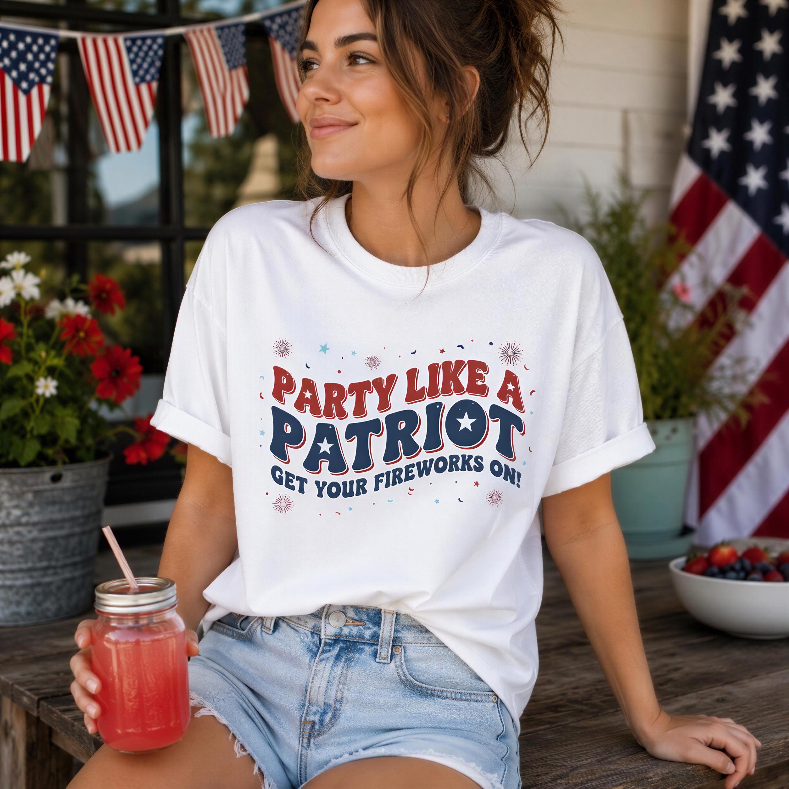 A woman wearing a white t-shirt with a patriotic message and holding a drink is sitting on a bench in front of an American flag.