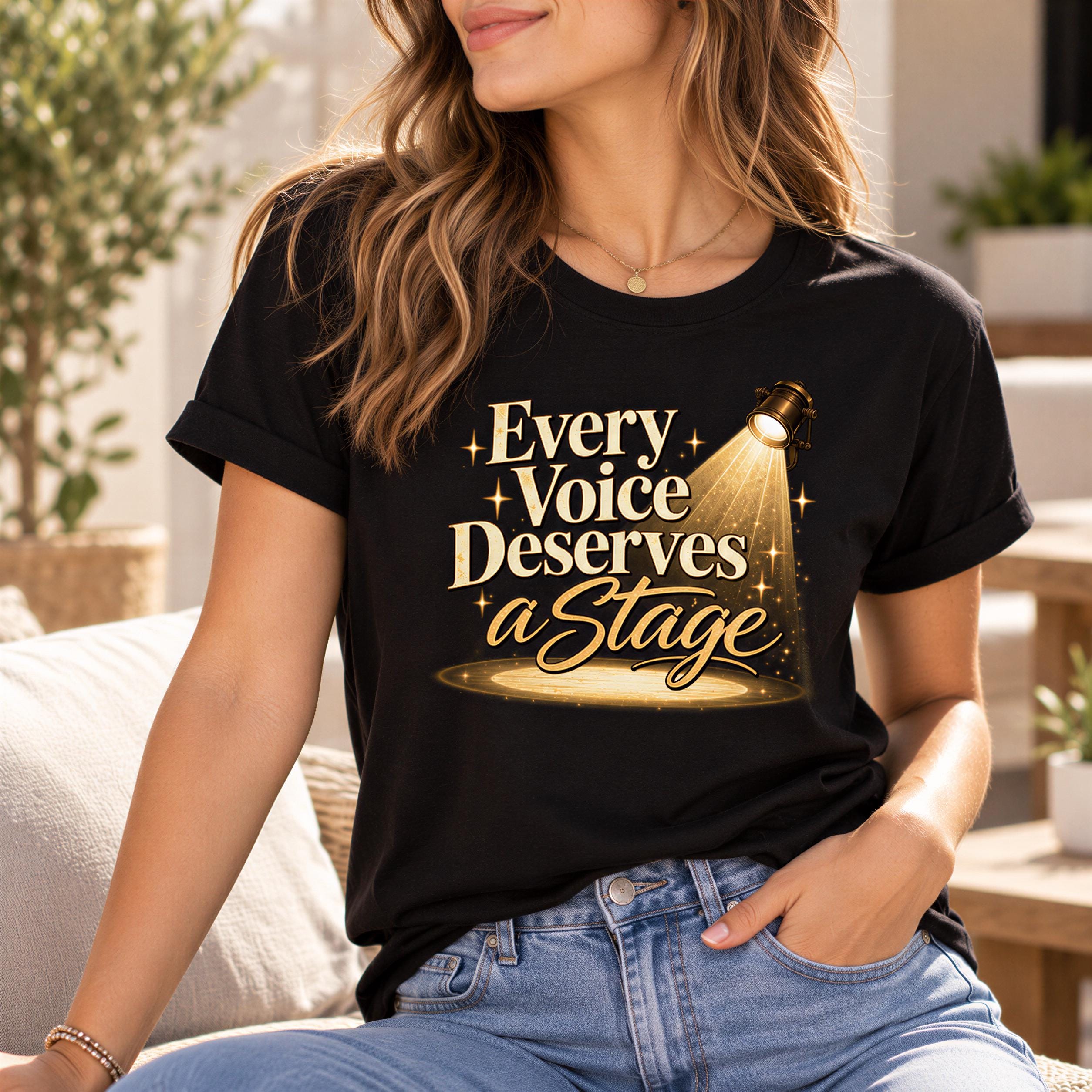 A woman wearing a black t-shirt with a graphic design that says "Every Voice Deserves a Stage" and a spotlight on it.