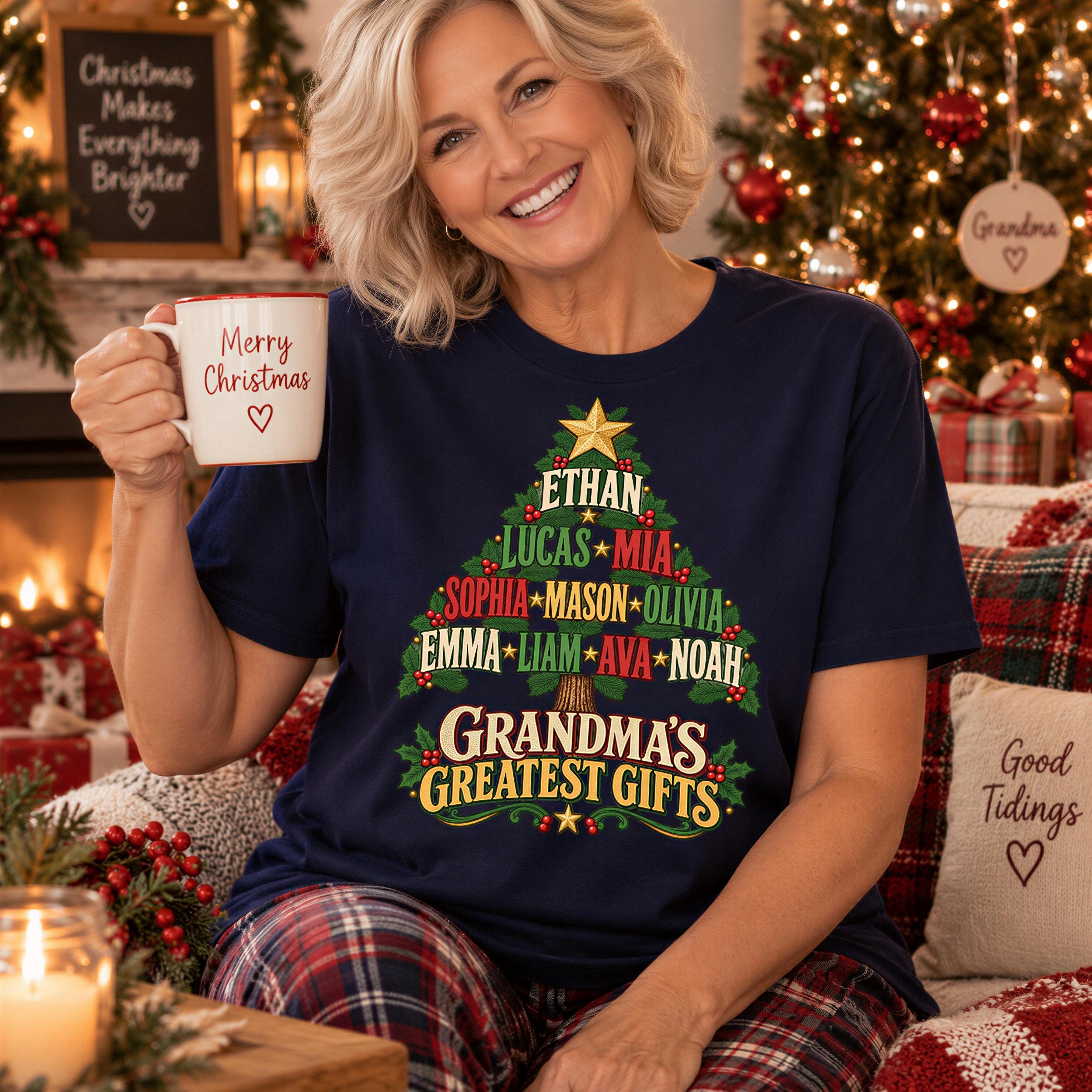 A smiling woman wearing a blue t-shirt with a Christmas tree design and text, holding a coffee mug, with a fireplace and Christmas decorations visible in the background.