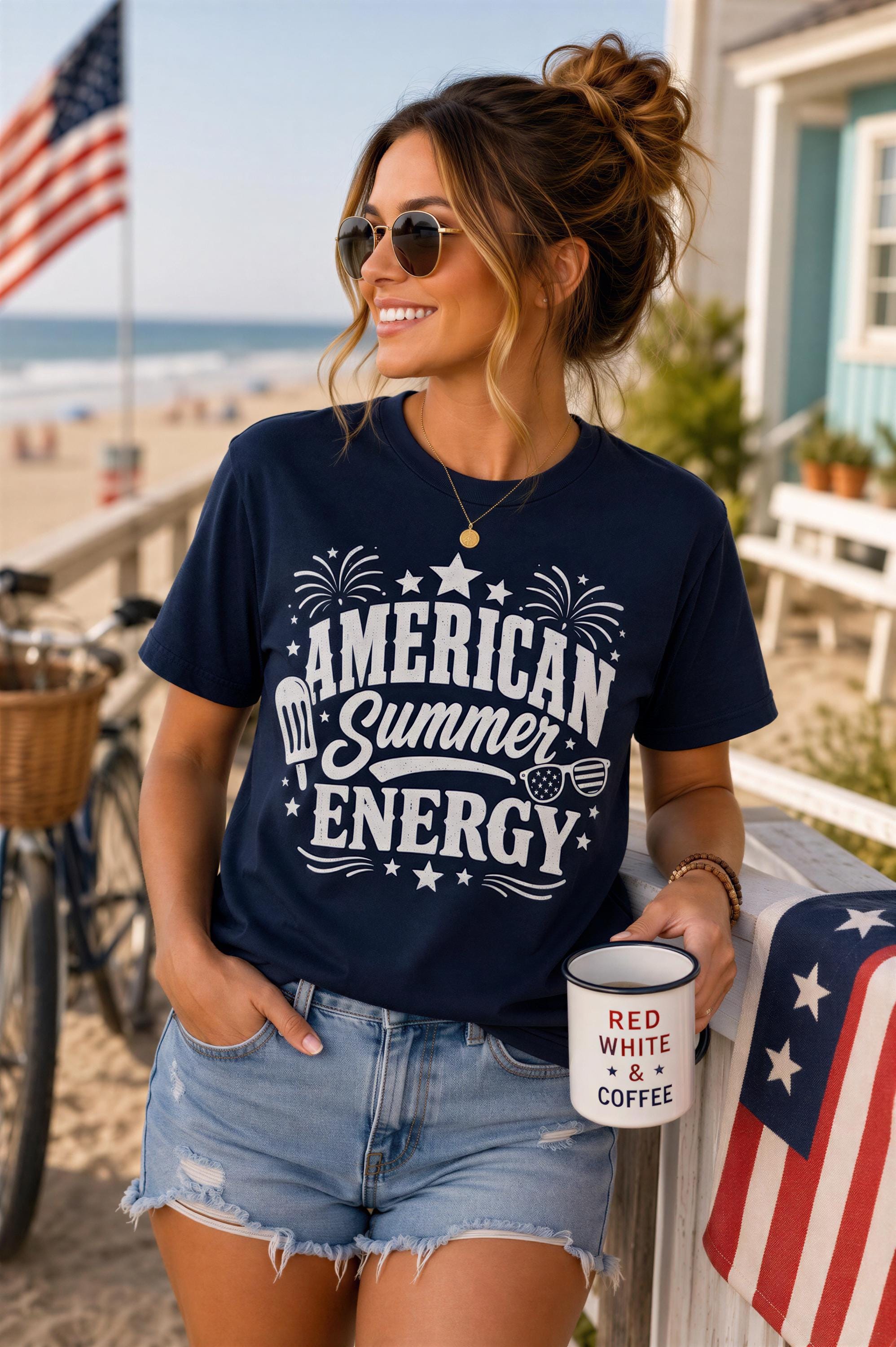 A woman wearing a navy blue t-shirt with the text "American Summer Energy" and sunglasses is standing on a beach, holding a white mug with the text "RED WHITE & COFFEE".