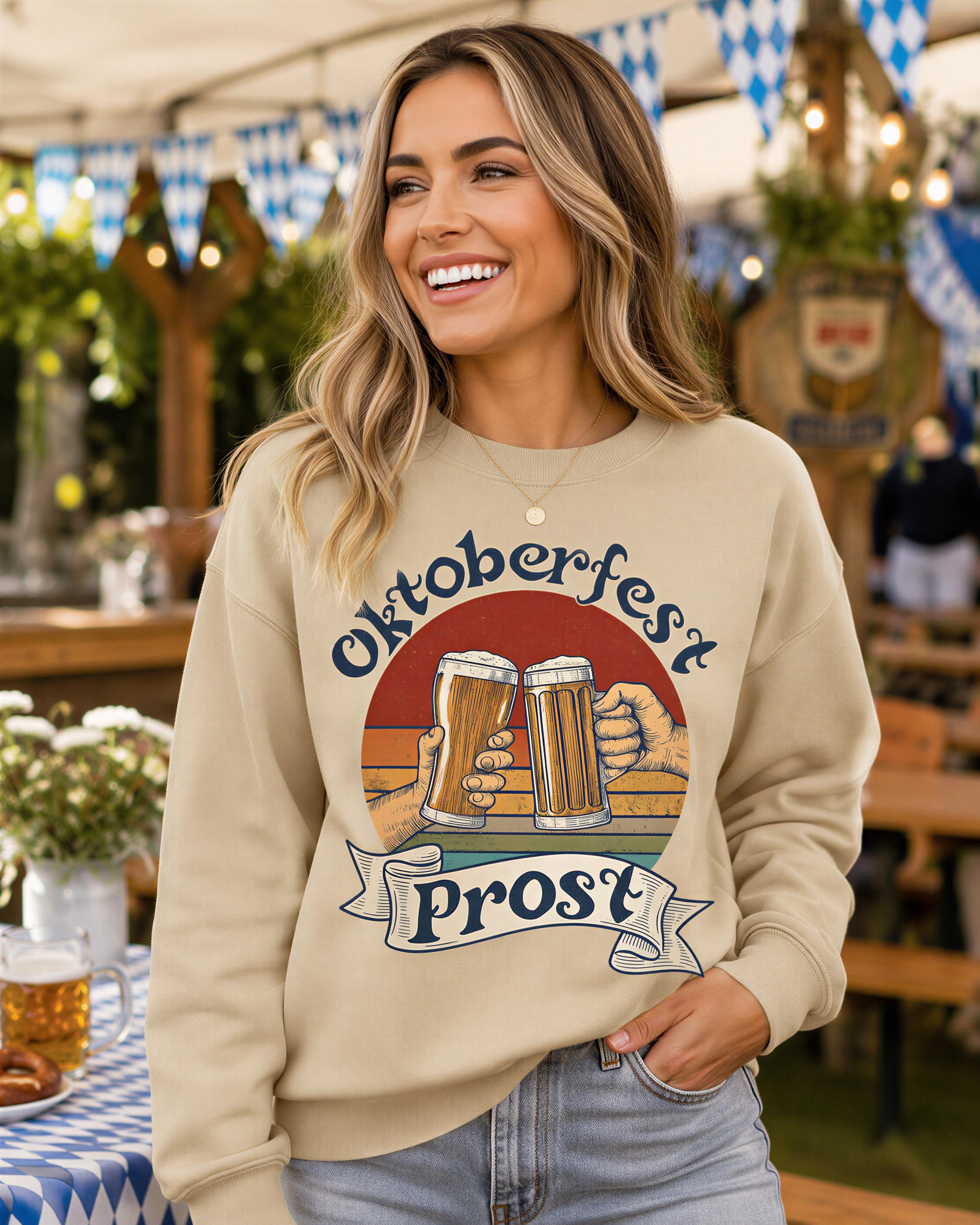 A smiling woman wearing a sweatshirt with a graphic of two beer glasses and the text "Oktoberfest Post" stands in front of a festive outdoor setting with blue and white checkered flags and a tent.
