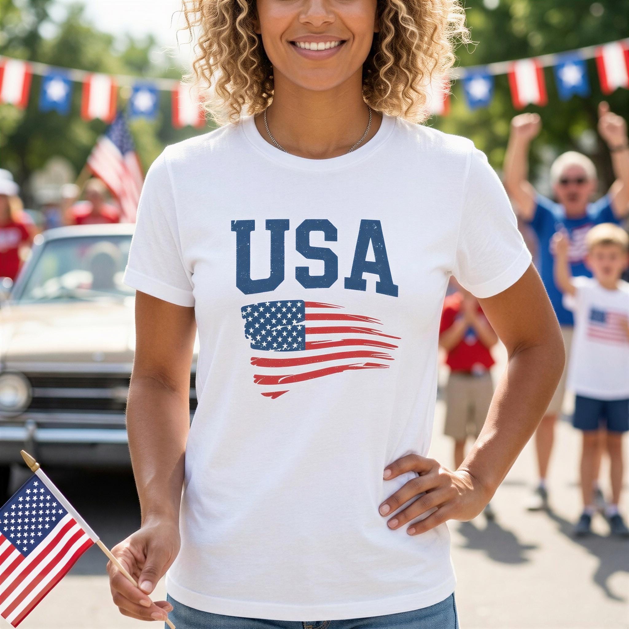 A woman wearing a white t-shirt with the word "USA" and an American flag design is smiling and holding a small American flag.