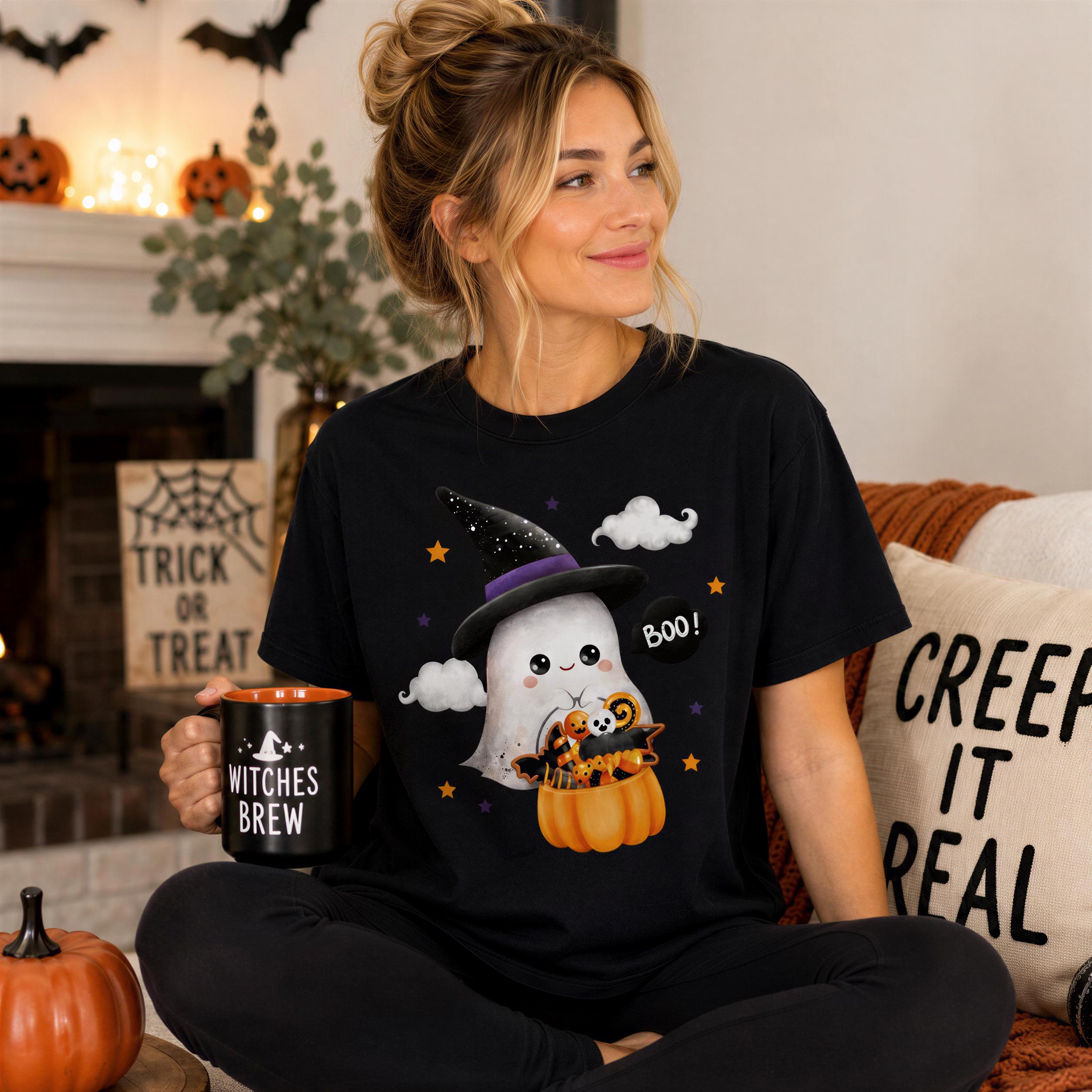 A woman wearing a black t-shirt with a Halloween-themed graphic is sitting on a couch, holding a mug with the text "WITCHES BREW" and a ghost character.