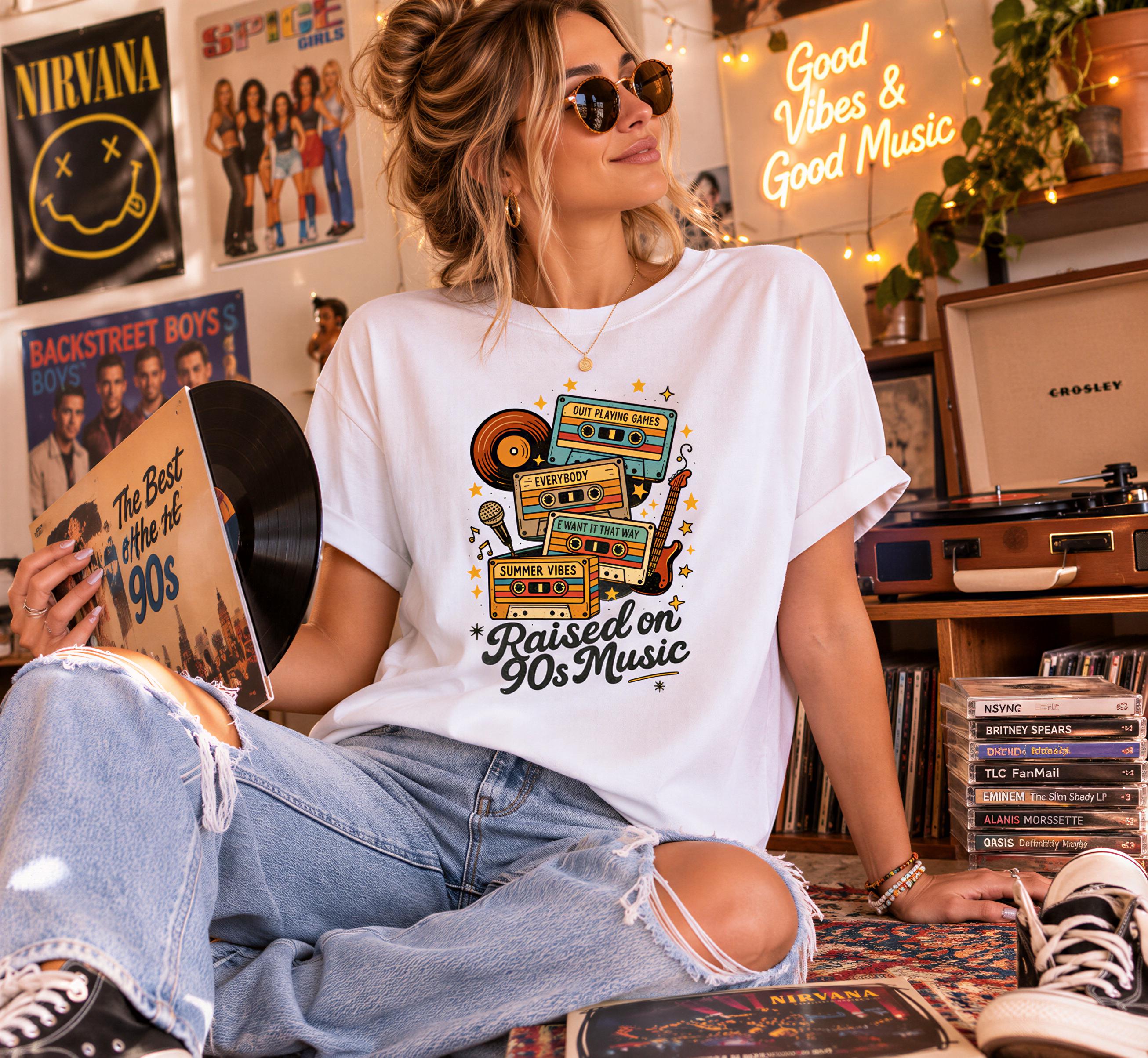 A woman wearing sunglasses and a white t-shirt with a graphic design is sitting on a rug surrounded by various music-related items, including vinyl records and CDs.