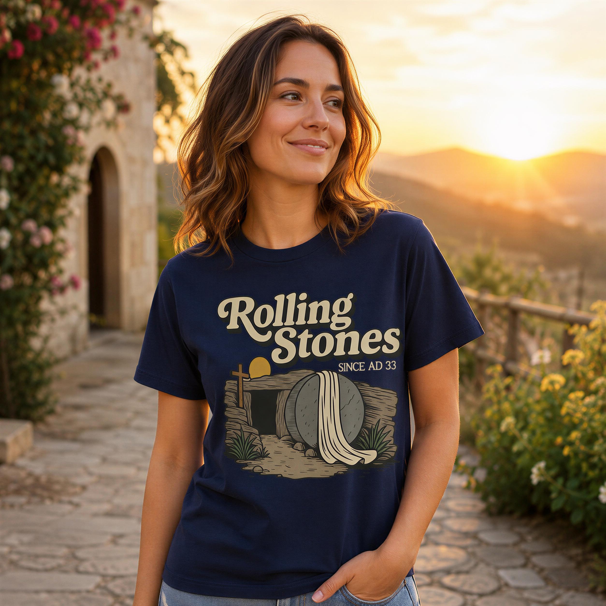 A woman wearing a Rolling Stones t-shirt stands in front of a scenic backdrop with a sunset and a stone building.